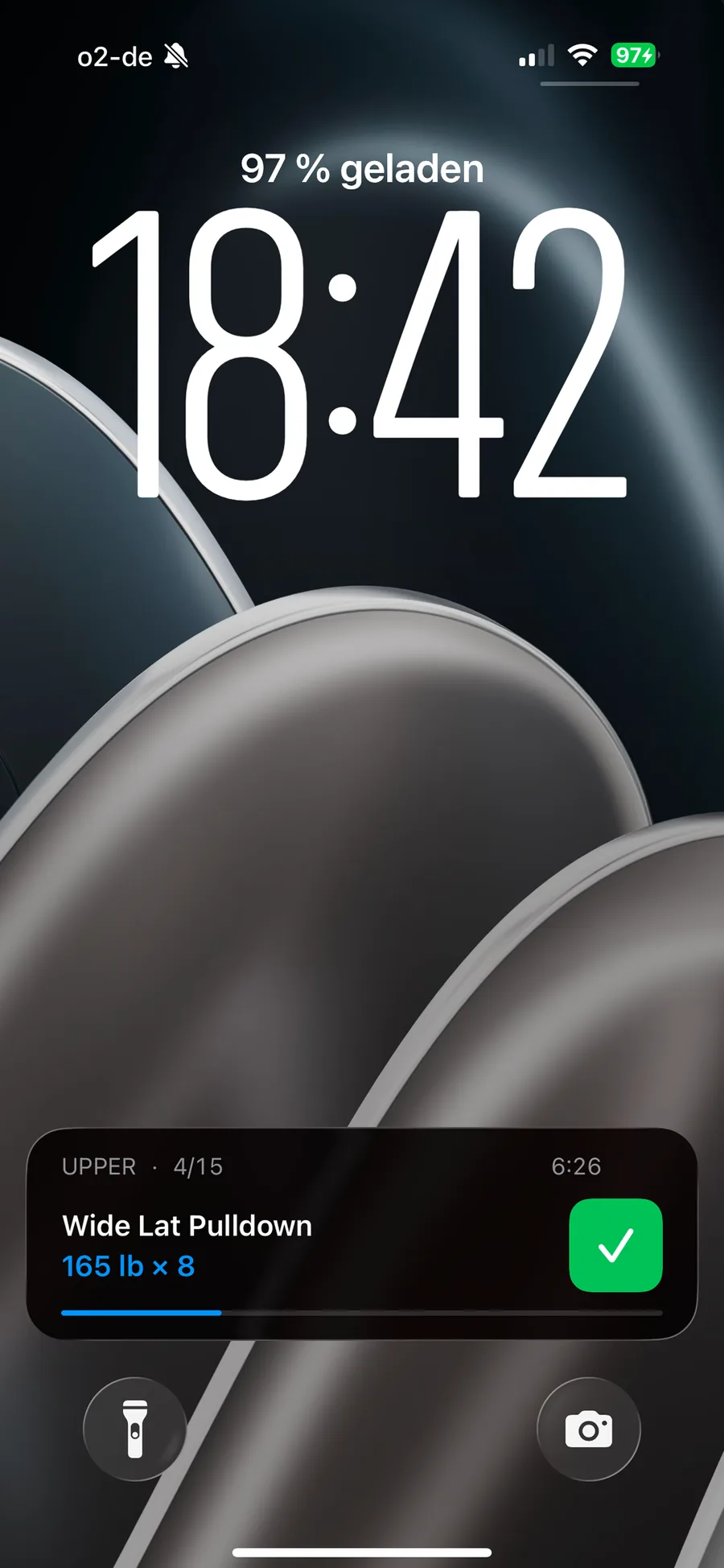 iPhone Lock Screen with a running gymLog workout: exercise, weight times reps, progress bar and a tick button